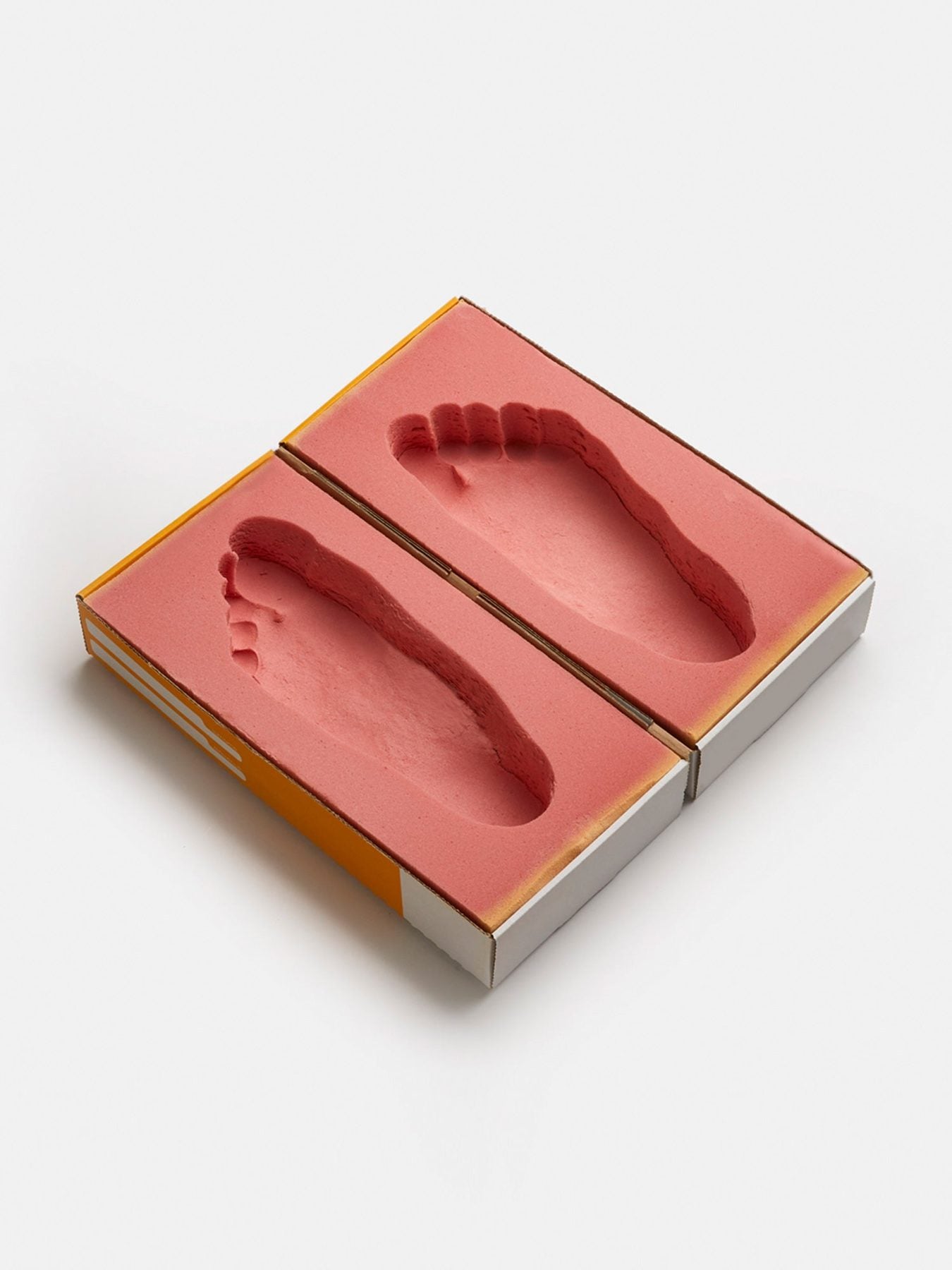 Our fit kit: two foam trays, each holding the impression of a foot