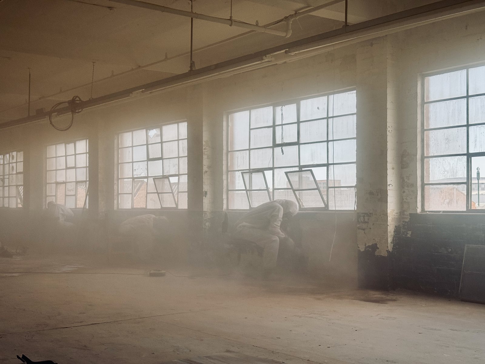 The factory floor during restoration, full of dust and light