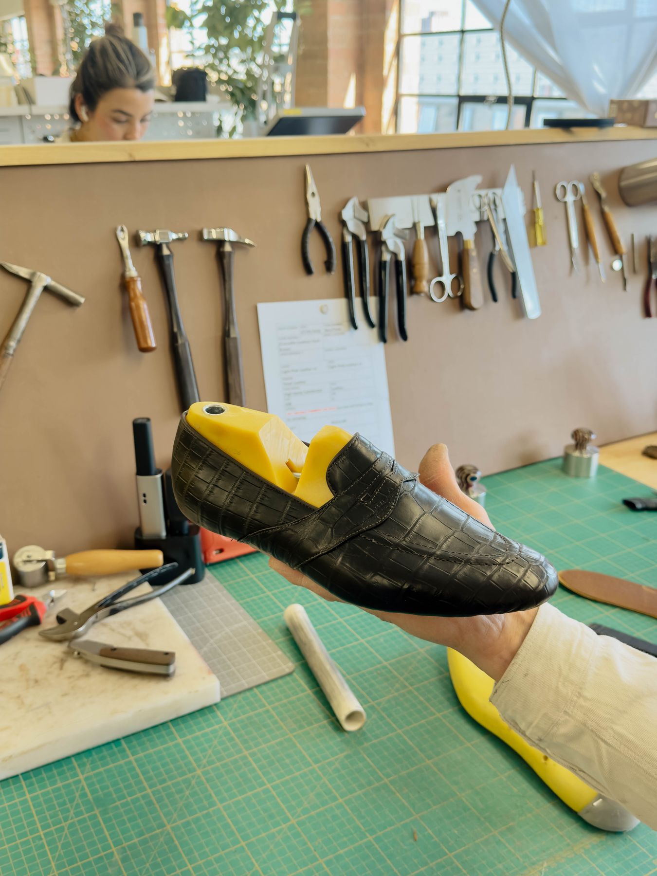 A shoe on its last at the bench