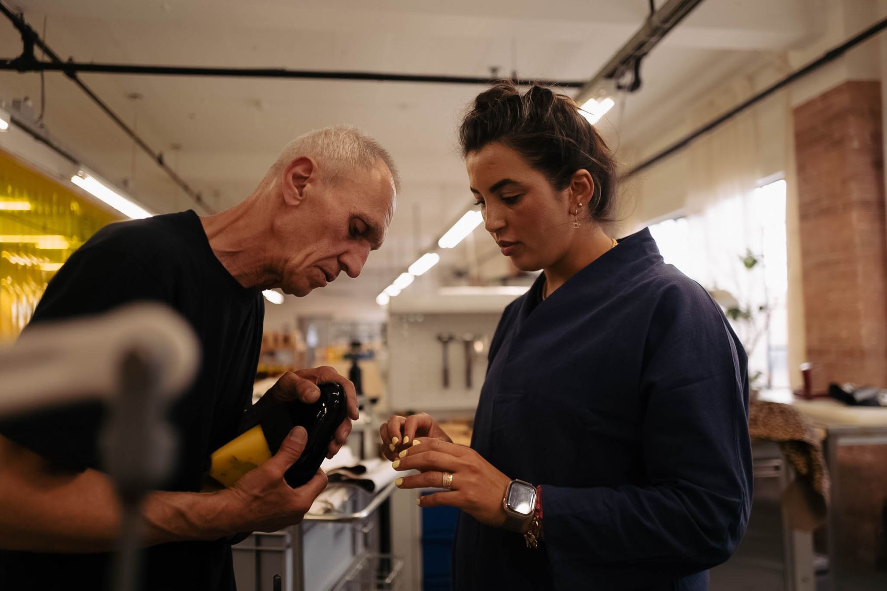Two of our makers looking at a shoe together