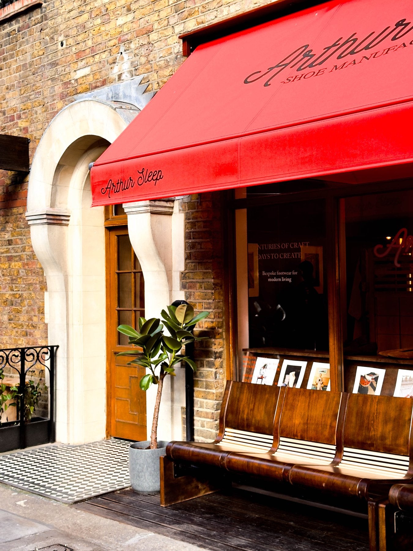 The arched door, the red awning and the bench outside