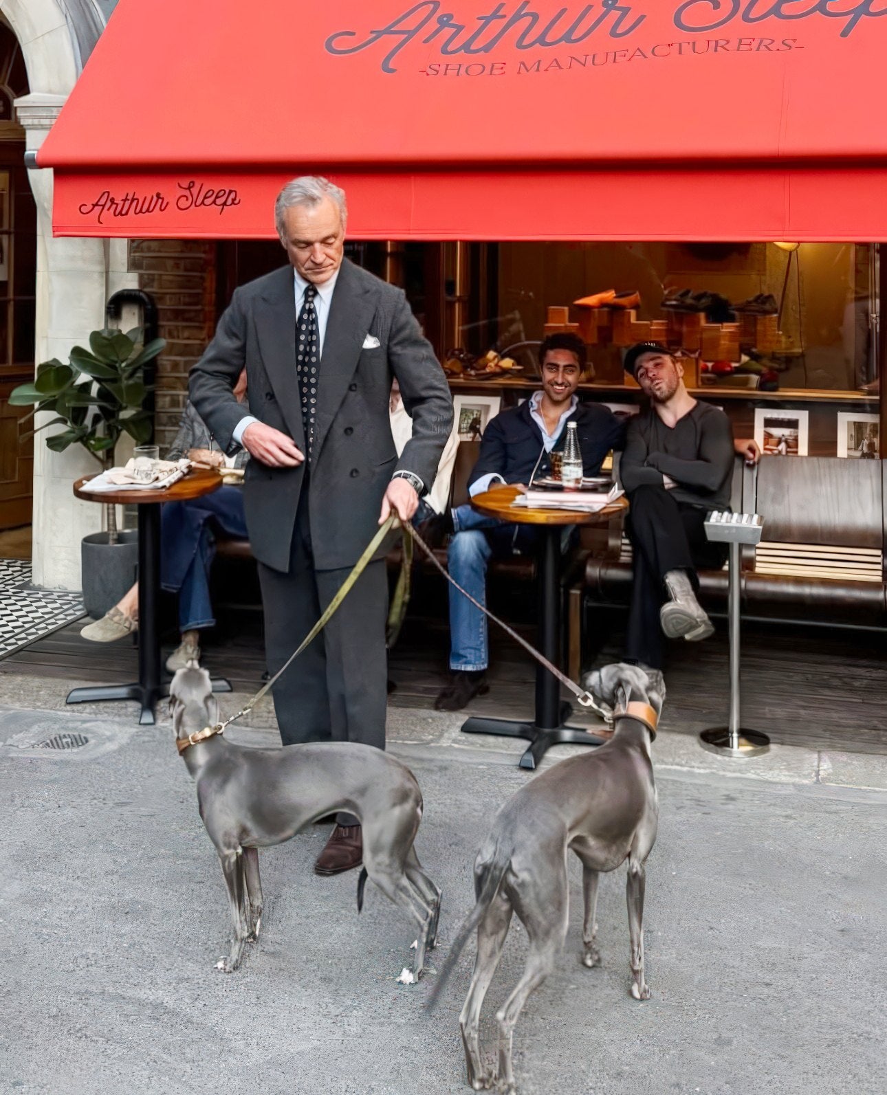 Friends outside the shop on Mount Street Mews, under the red awning